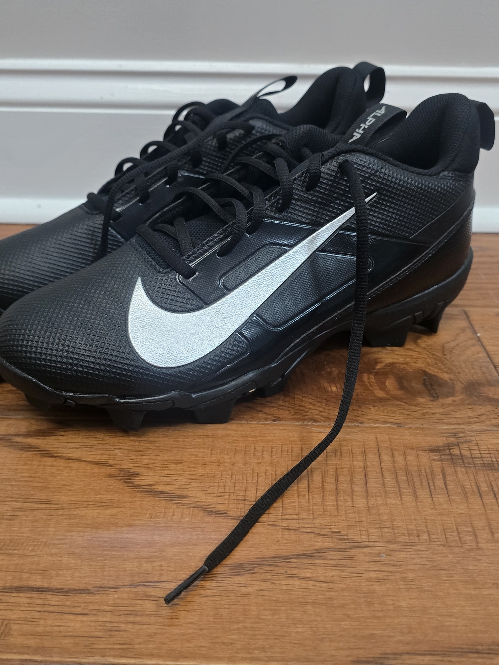 Nike Men’s Black Cleat with Silver Swoosh